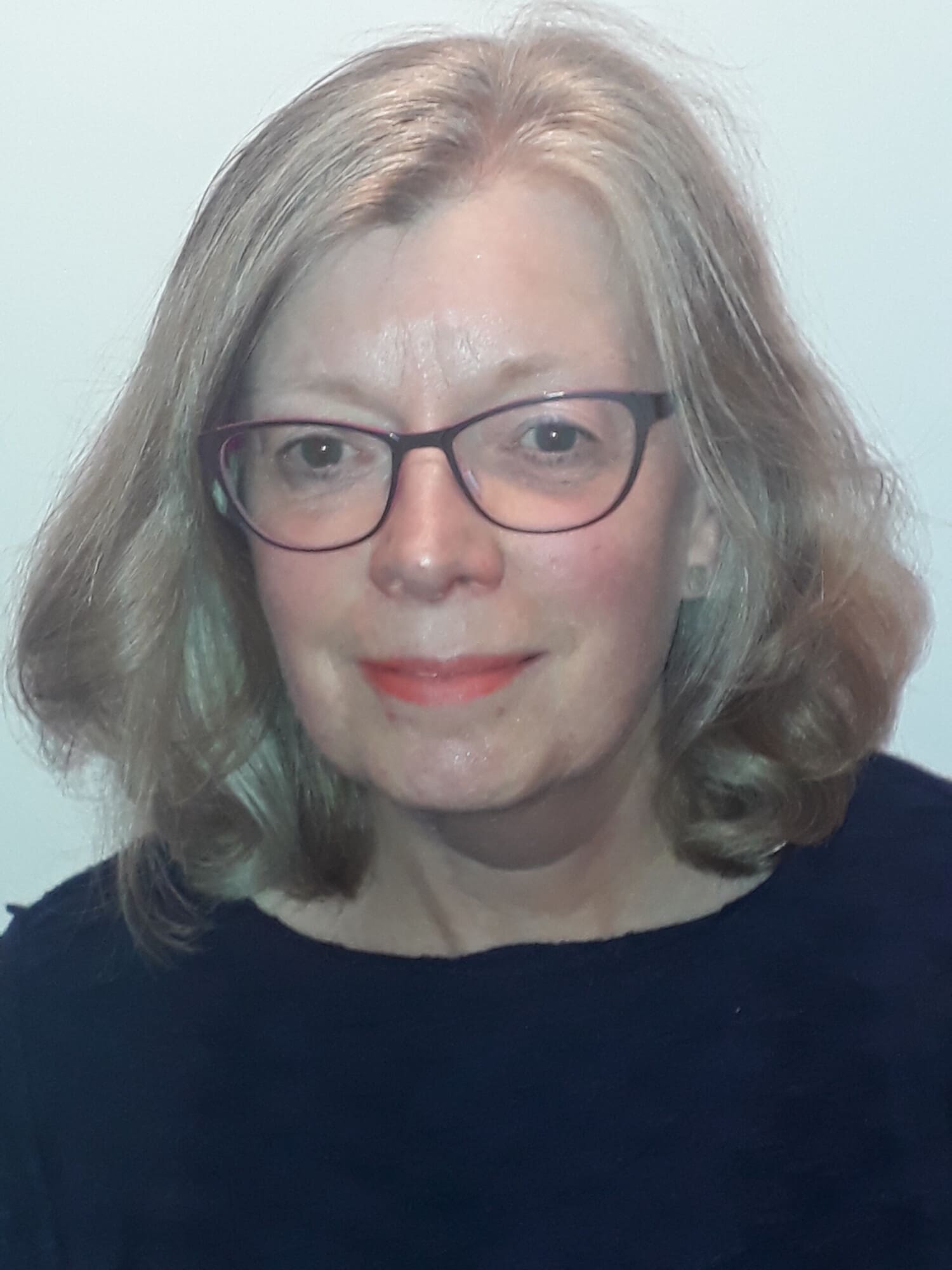 Photo of lady with shoulder length hair and glasses - Sandra Sutherland