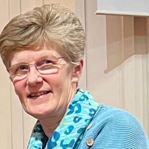 Megan Patterson, head shot wearing blue jumper and scarf